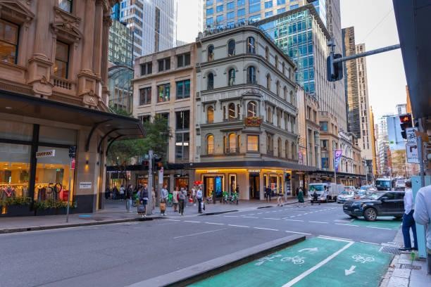 Streetscape with historic buildings, pedestrians and a bike lane in Melbourne